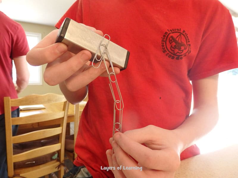 Tower of paper clips hanging off a magnet.