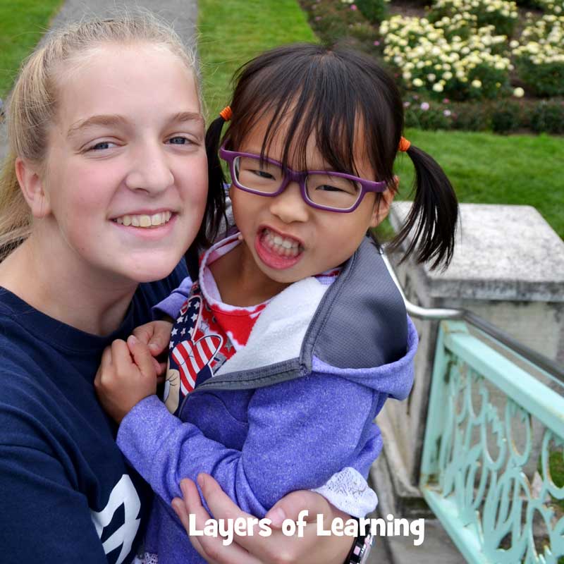 Teenager who signs holding a deaf child